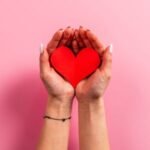 woman-holding-a-red-heart-in-her-hands