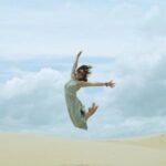 woman-leaping-happy-sand-dunes